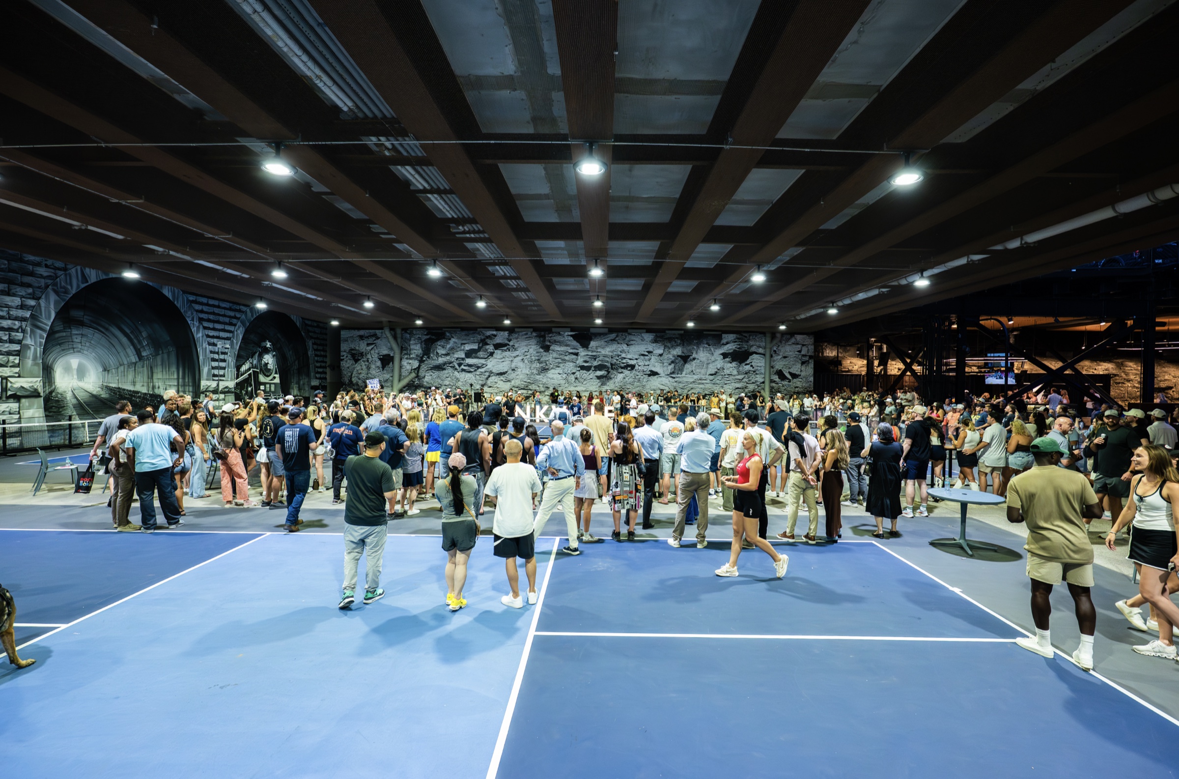 A packed private event across the courts at Dinkville Under Broad